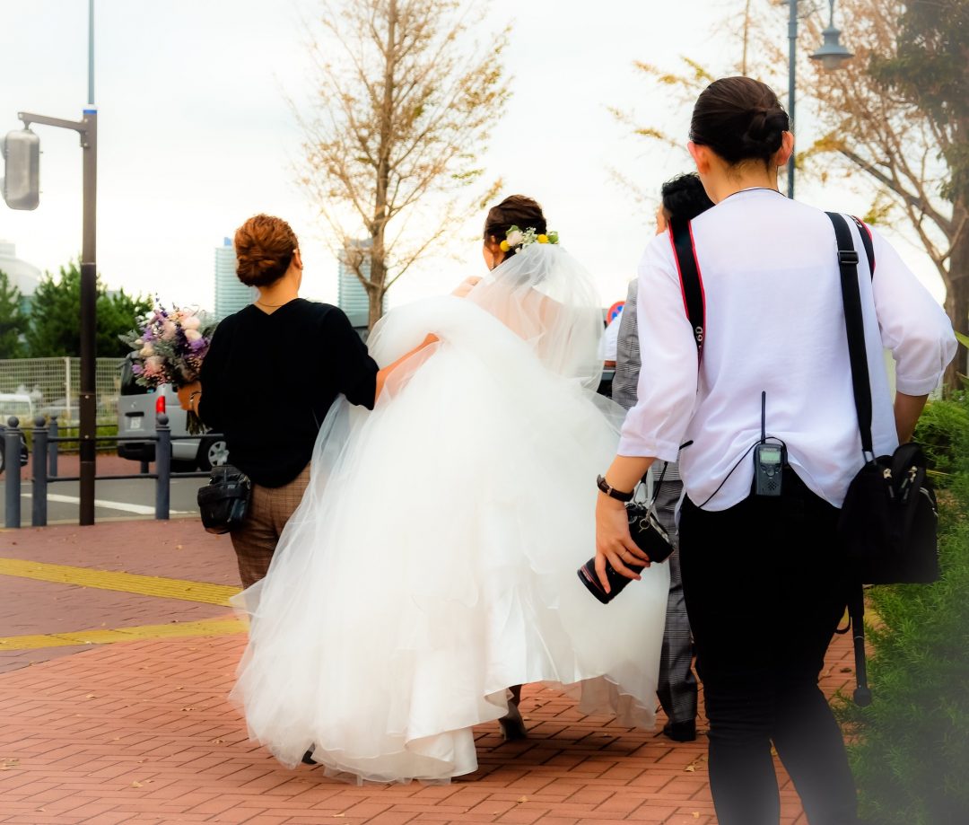 a-white-dressed-bride-with-an-entourage-of-photographers.jpg